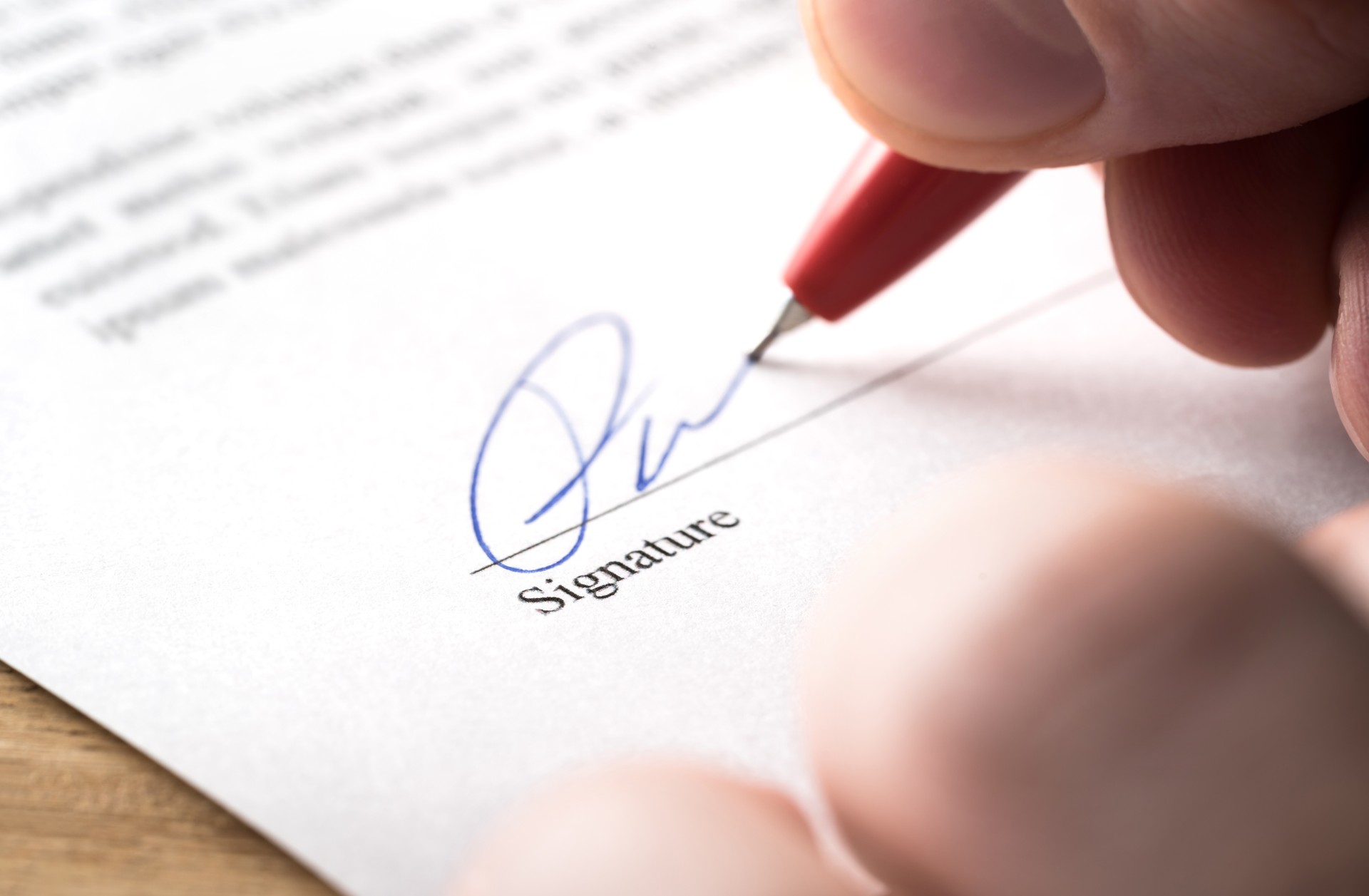 Signing contract, lease or settlement for acquisition, apartment lease, insurance, bank loan, mortgage or business buyout. Man writing name and autograph with pen. The signature is made up.